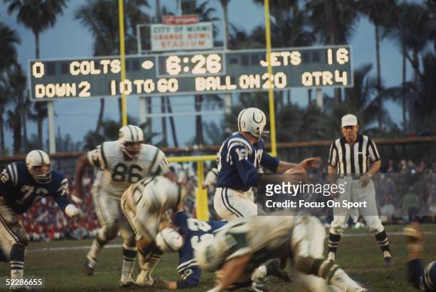 Baltimore Colts' Johnny Unitas looks for a receiver as the New York Jets close in for a tackle during Super Bowl III at the Orange Bowl on January...