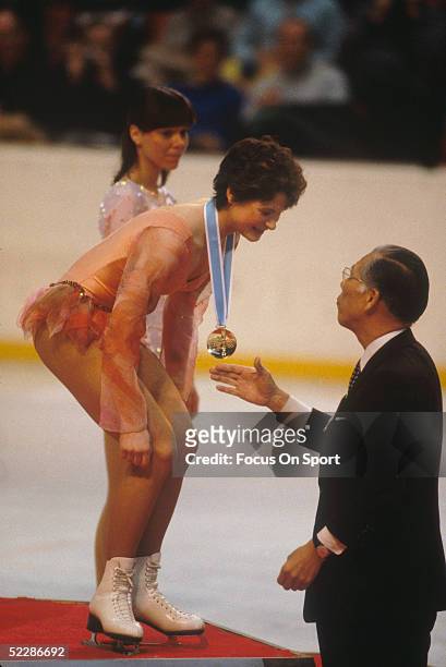 Figure skater recieves her gold medal from an Olympic official during the XIII Olympic Winter Games in February of 1980 in Lake Placid, New York.