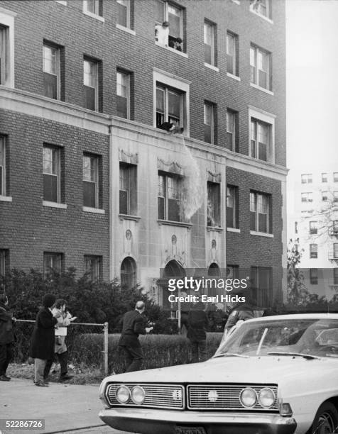 As police rush the front door of Madison Hall on the George Washington University campus, students pour water on them from out of the third floor...