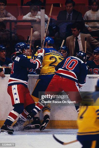 Team USA's coach Herb Brooks watches his players check a team Sweden player into the players' bench during the XIII Olympic Winter Games in February...