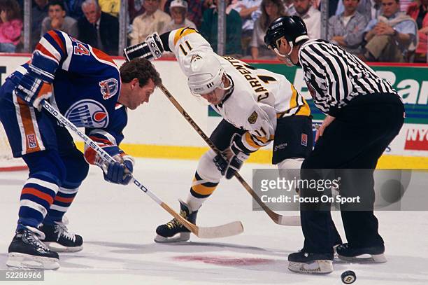 Edmonton Oilers' Craig MacTavish faces off against Boston Bruins' Bob Carpenter#11 during the Stanley Cup Finals at the Boston Garden circa 1990 in...