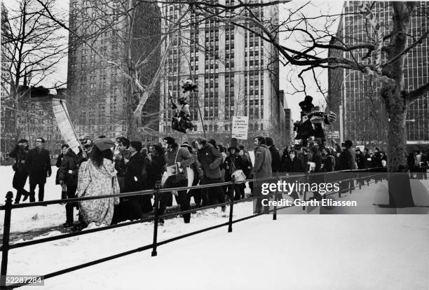 Demonstrators parade through City Hall Plaza carrying effigies, drums, fifes, and other items, New York, New York, February 16, 1970. The protest was...