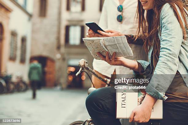 tourists with guide and map in alleys of italy - bike ipad stock pictures, royalty-free photos & images