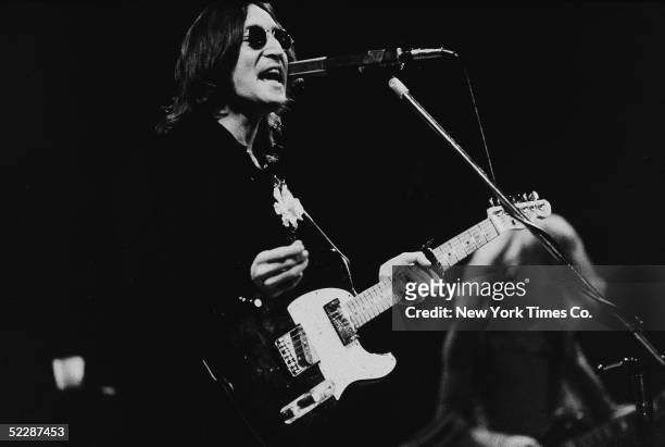 British musician John Lennon performs onstage in Madison Square Garden, New York, New York, November 28, 1974.