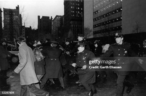 After the barricades are broken in front of the Criminal Courts Building, police officers begin to break up groups of protestors who responded with...