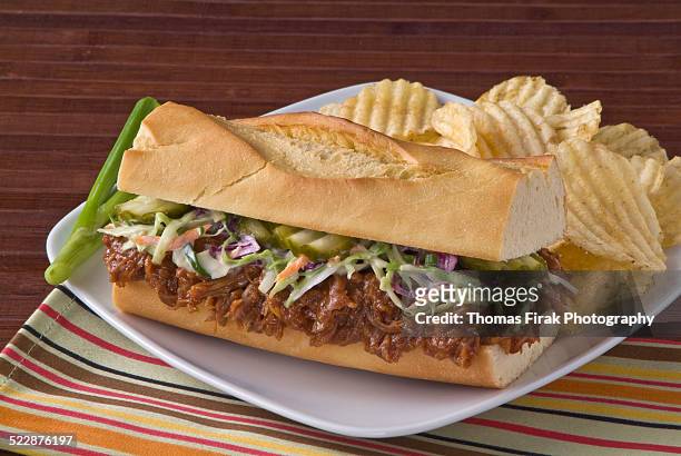 pulled pork sandwich on roll with coleslaw -  firak stock pictures, royalty-free photos & images