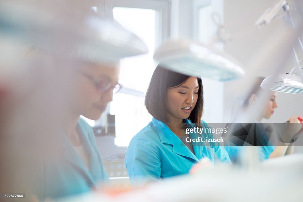 Female students learning prosthetic dentistry