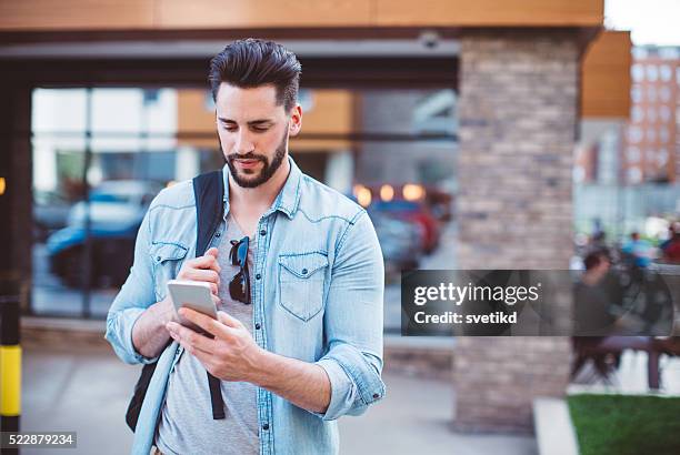 living in a digital world - young men walking stock pictures, royalty-free photos & images