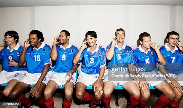 soccer team talking on cell phones - soccer team stock pictures, royalty-free photos & images