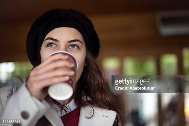 pretty turkish student having coffee while waiting for ferryboat, istanbul - turkish coffee drink stock pictures, royalty-free photos & images