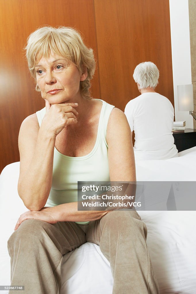 Upset senior couple in the bedroom