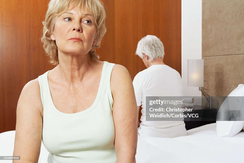 Unhappy older couple in bed