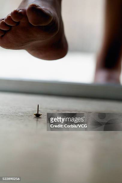 close up of a person about to step on a tack - pointed foot stock pictures, royalty-free photos & images