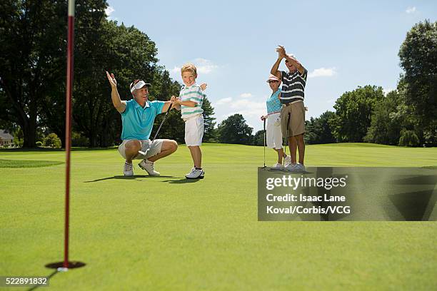 boy (6-7) after successful shot on golf course - putting clothes son stock pictures, royalty-free photos & images