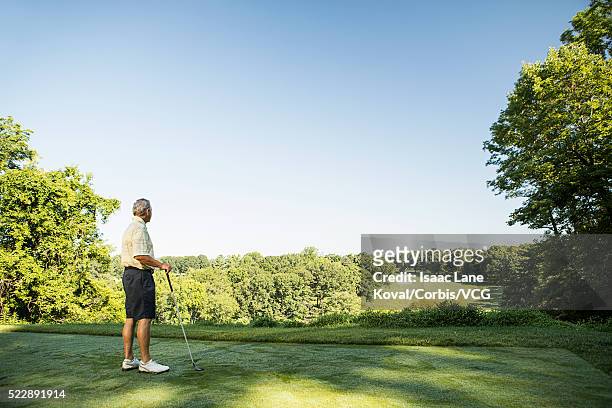 senior man on golf course - ティーグラウンド ストックフォトと画像