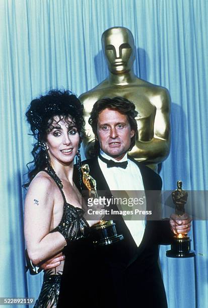 Cher and Michael Douglas attends the 60th Academy Awards at the Shrine Auditorium on April 11, 1988 in Los Angeles, CA.