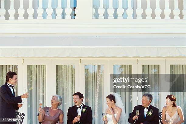 portrait of the best man toasting a bride and groom at a wedding reception - embarrased dad stock pictures, royalty-free photos & images