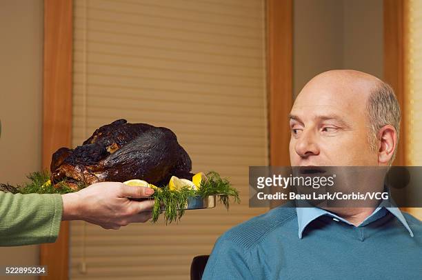 man looking at burnt turkey - funny rooster stockfoto's en -beelden