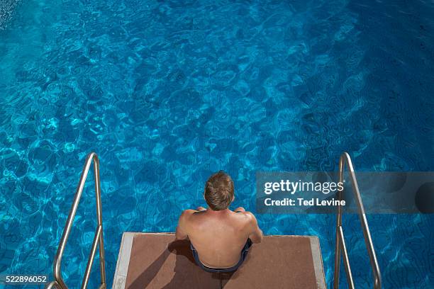 diver sitting on diving platform - diving platform view stock pictures, royalty-free photos & images