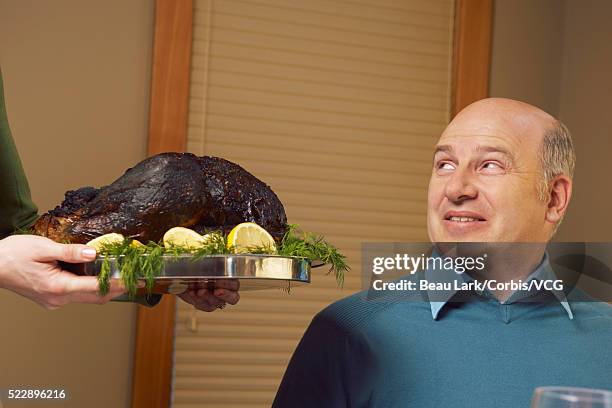 man being served burnt turkey - funny turkey images stock pictures, royalty-free photos & images