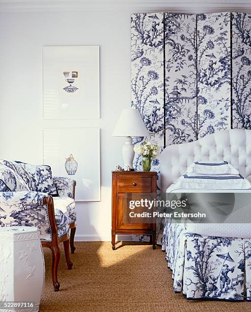 bedroom with coordinating pattern on screen and settee - headboard stock pictures, royalty-free photos & images