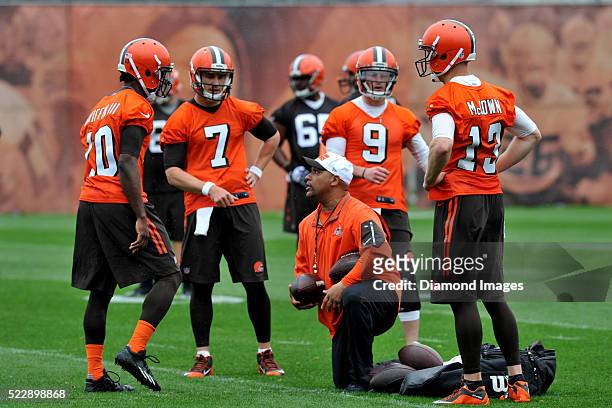 Head coach Hue Jackson of the Cleveland Browns talks with quarterbacks Robert Griffin III, Josh McCown, Austin Davis, and Connor Shaw during a...