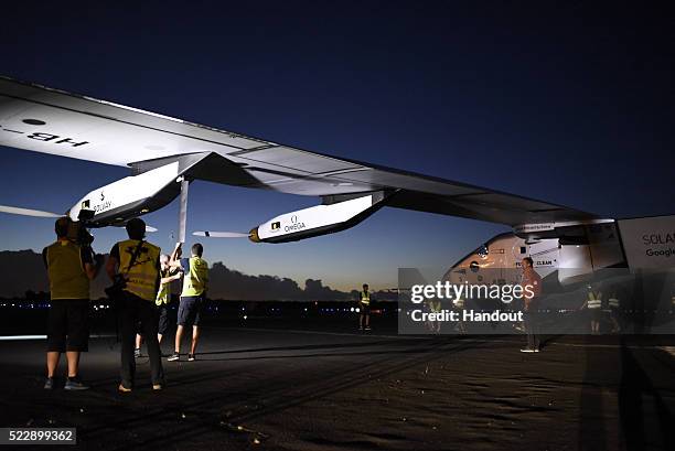 In this handout image supplied by Solar Impulse 2/GNR, team members are working on the plane short before "Solar Impulse2", a solar powered plane...