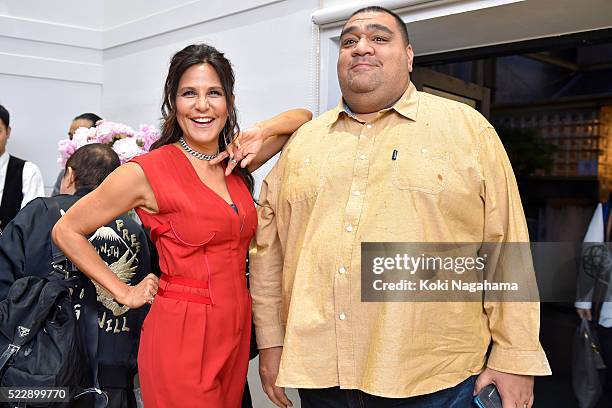 Laurie Lynn Stark and Former sumo wrestler Musashimaru pose for a photograph during the opening event for 'Bud'N' Blooms' By Laurie Lynn Stark at...