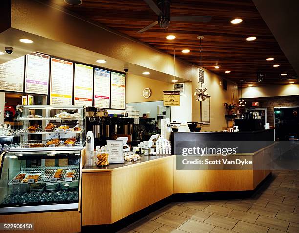 pastries are displayed near the counter of a coffee shop - café bar fotografías e imágenes de stock