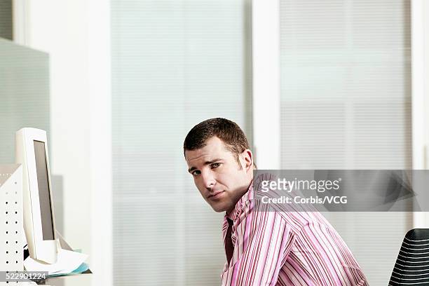 businessman facing the camera in office setting - business person facing away from camera stockfoto's en -beelden