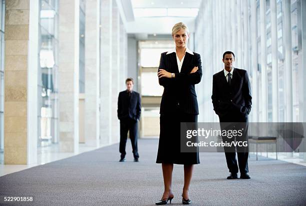 full body portrait of a businesswoman in an office setting - man standing full body photos et images de collection