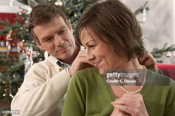 gift giving at christmas - pearl necklace stock pictures, royalty-free photos & images