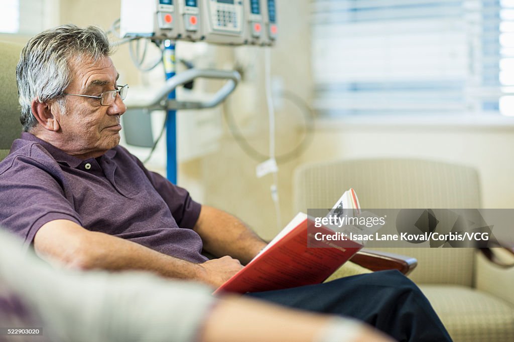 Patient reading book in infusion room