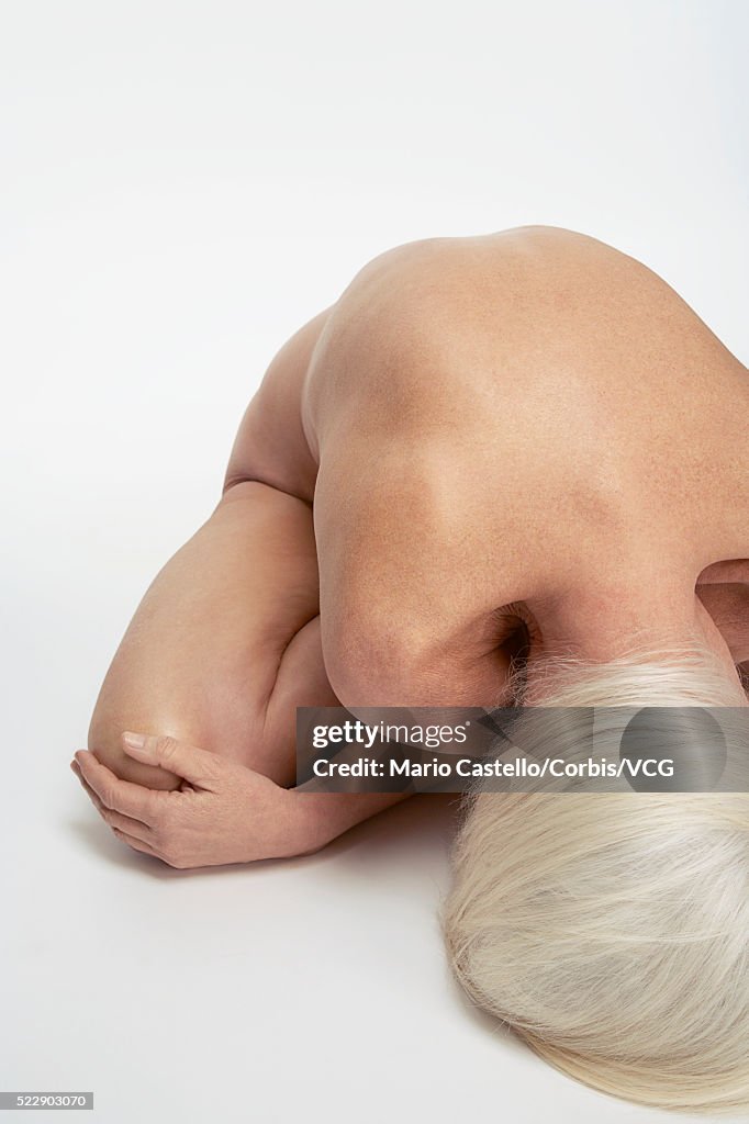 Nude woman bending over