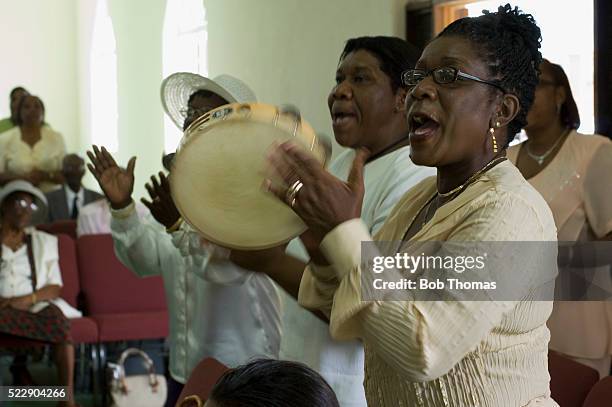 members of a church singing during a service - congregation stock-fotos und bilder