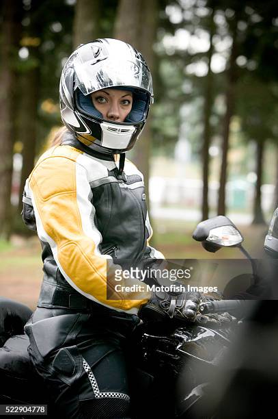 motorcyclist sitting on her motorcycle - vintage motorcycle helmet stock pictures, royalty-free photos & images