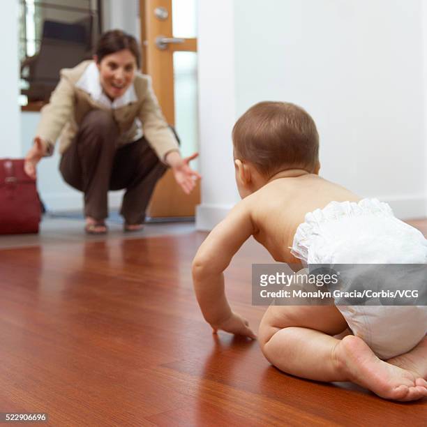 businesswoman coming home to baby daughter - coming back stock pictures, royalty-free photos & images