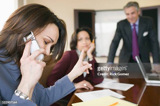 rude businesswoman in meeting - inconvenience stock pictures, royalty-free photos & images