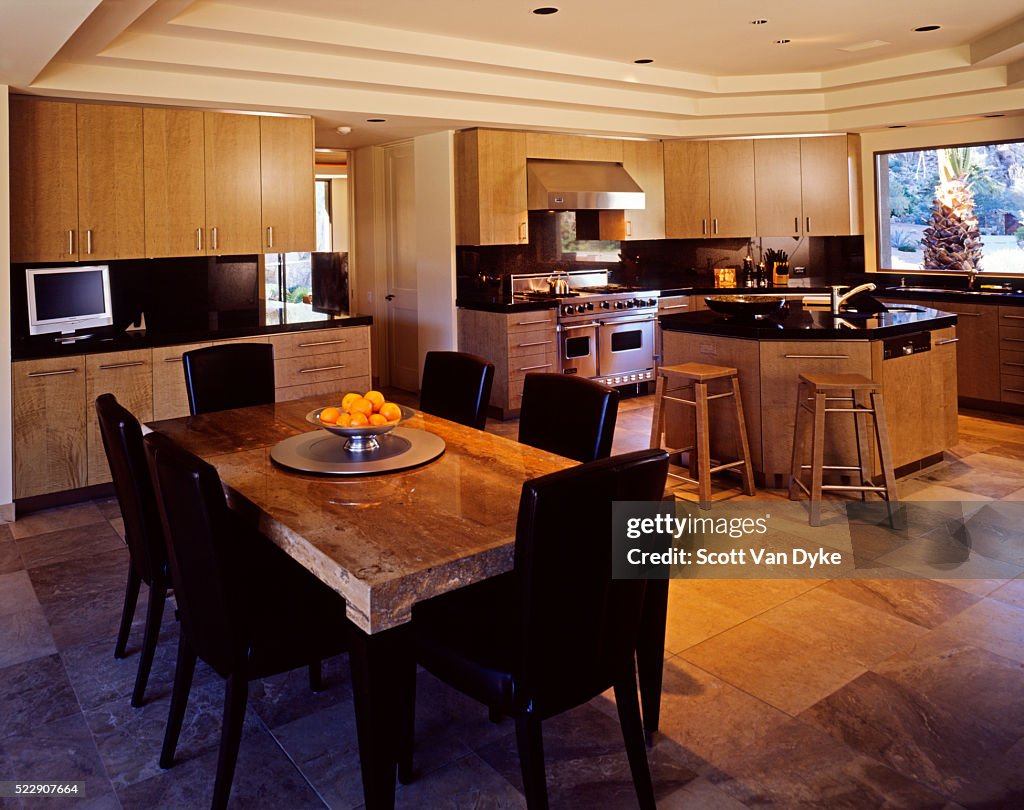 Marble pervades this sleek contemporary kitchen and dining area