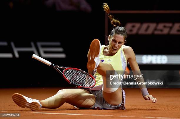 Andrea Petkovic of Germany falls during her match against Agnieszka Radwanska of Poland during Day 4 of the Porsche Tennis Grand Prix at...