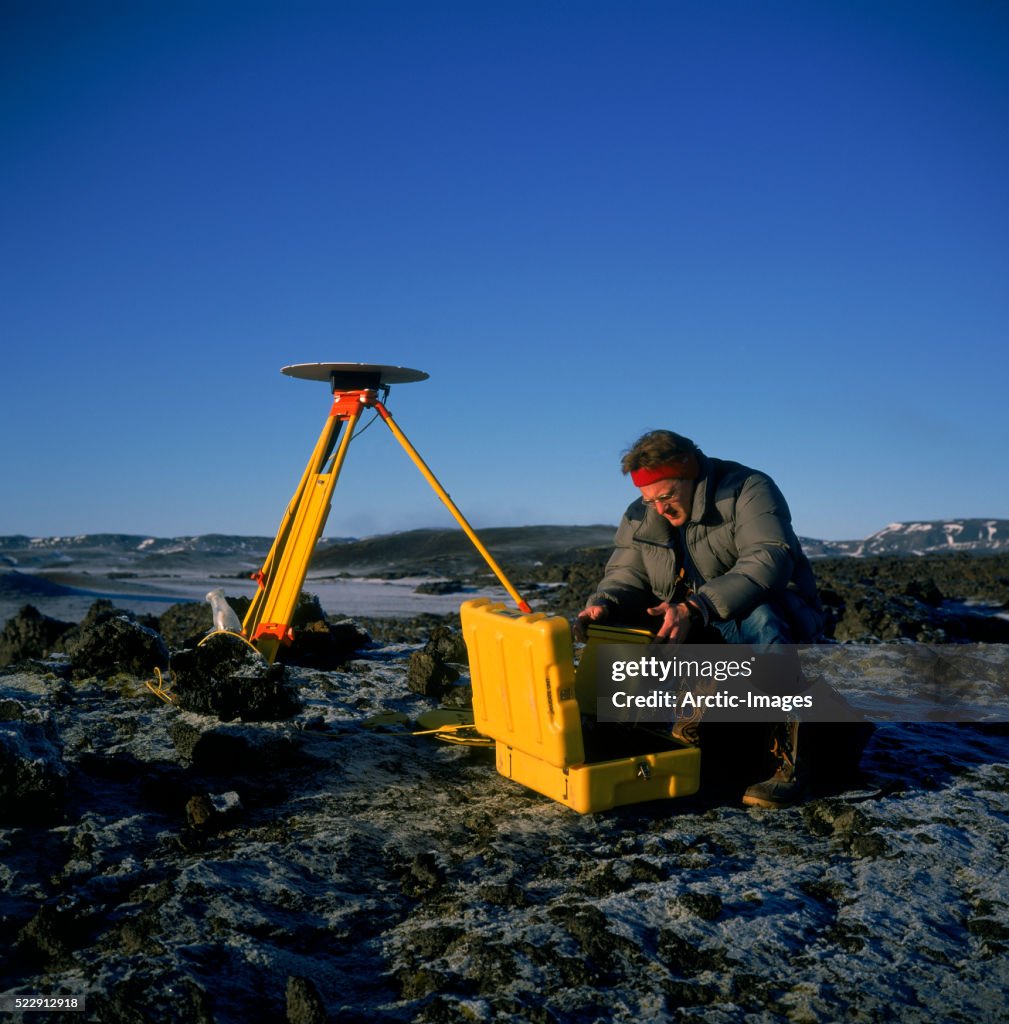 Scientist with GPS Equipment Measuring Earth Movements in Iceland