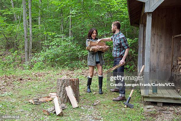 couple gathering firewood in forest - frank wood stock pictures, royalty-free photos & images