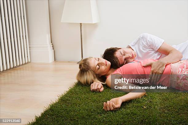 couple lying on turf on floor - white van profile stock pictures, royalty-free photos & images