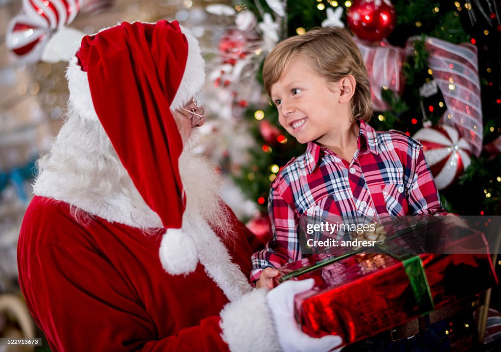 Boy getting a Christmas gift from Santa