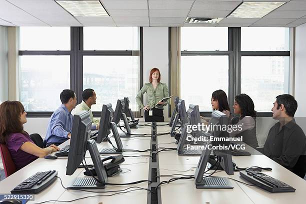 businesswoman leading training session - people sitting in a row stock pictures, royalty-free photos & images