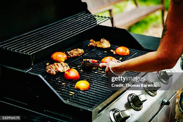 woman grilling nectarines and chicken on barbecue - peach tranquility stock pictures, royalty-free photos & images