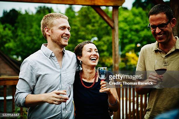 Couple drinking wine with friends on deck