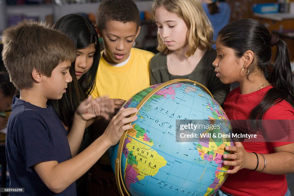Third Grade Students Looking at Globe