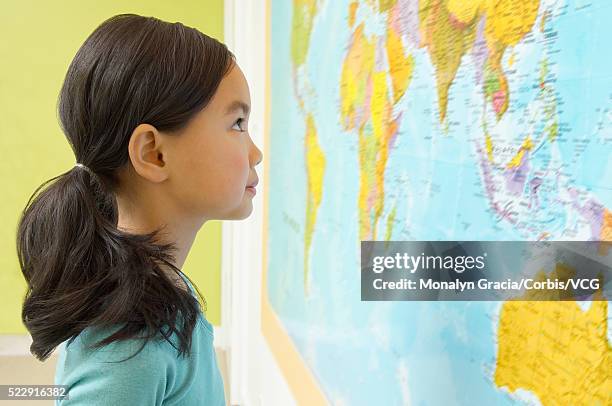 girl looking at world map - bottomless girls stockfoto's en -beelden