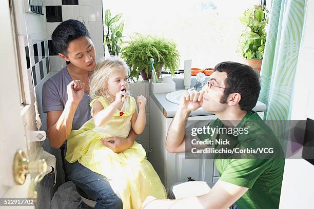 fathers teaching daughter to brush teeth - sideburn stock pictures, royalty-free photos & images